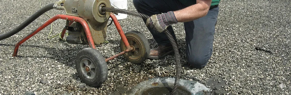 sewer rodding technician actively removing blockages from a sewer line in Madison, WI